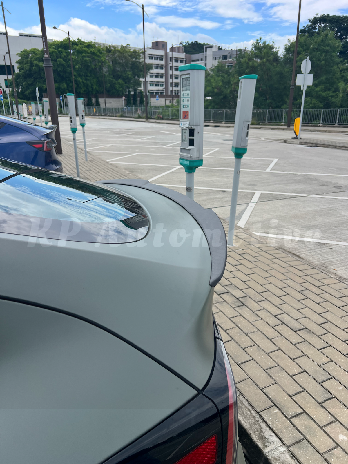 Matte finish dry carbon rear spoiler lip on car trunk, angled side view