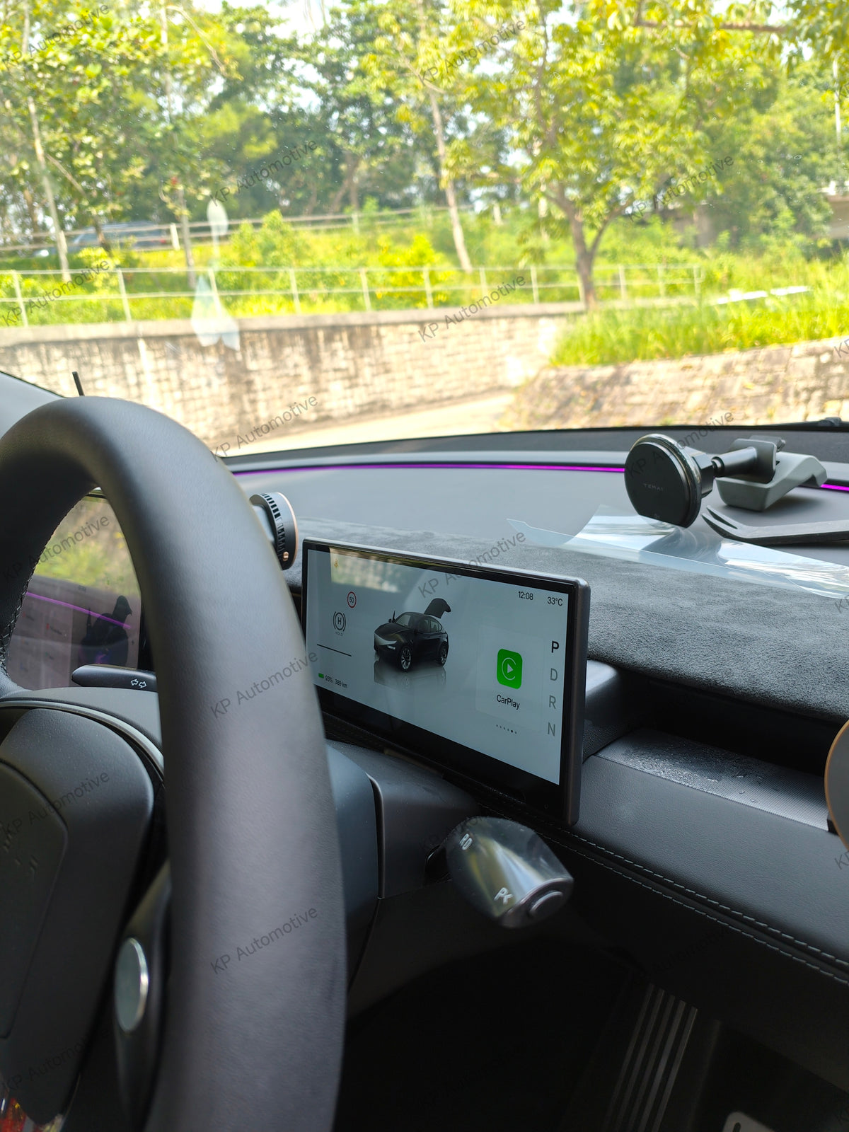 Car dashboard display with airflow vent, in-car screen showing app interface